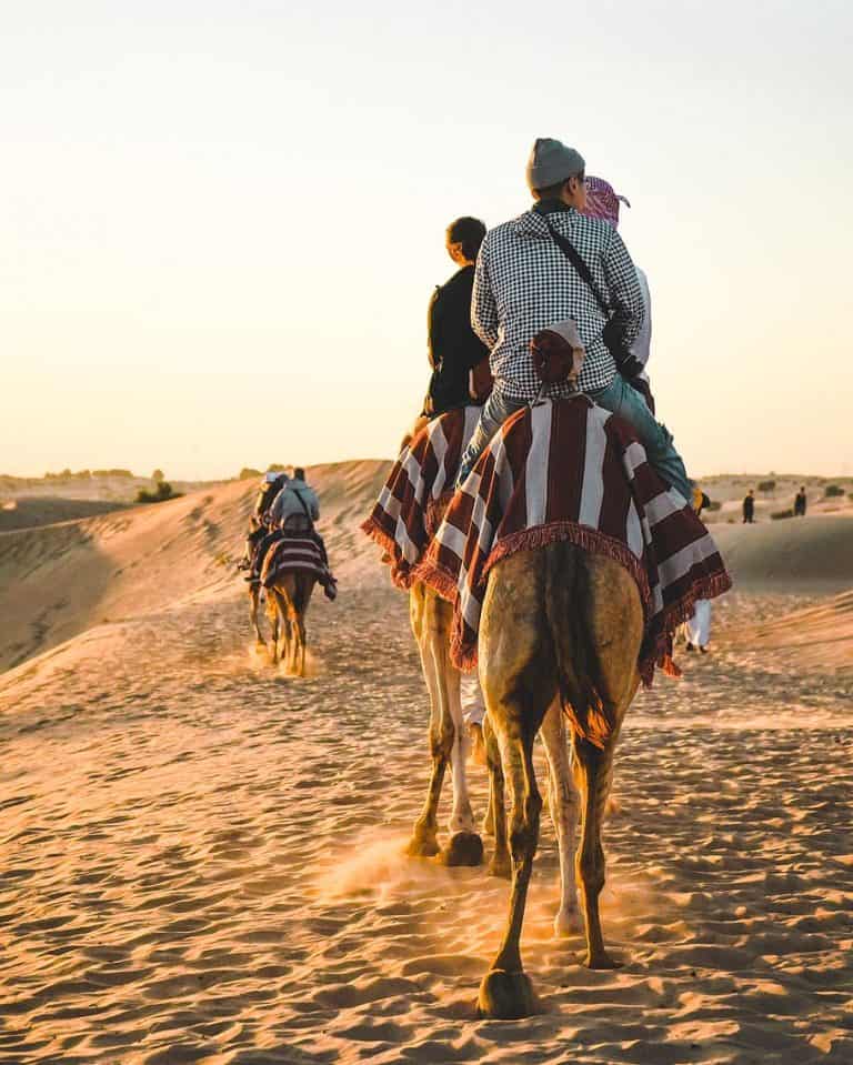 people-riding-camel-at-sahara-desert