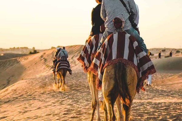 people-riding-camel-at-sahara-desert